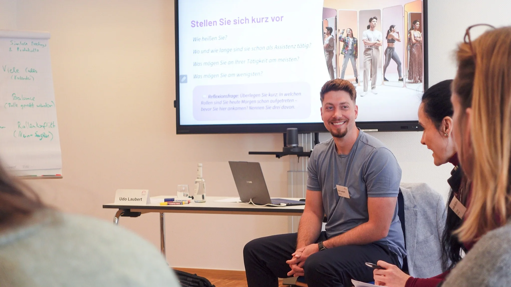 Udo Laubert sitzt lächelnd im Austausch mit einer Workshopgruppe.